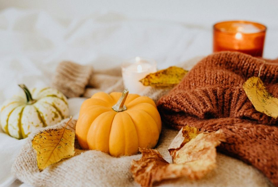 Pumpkins, fall leaves and a candle