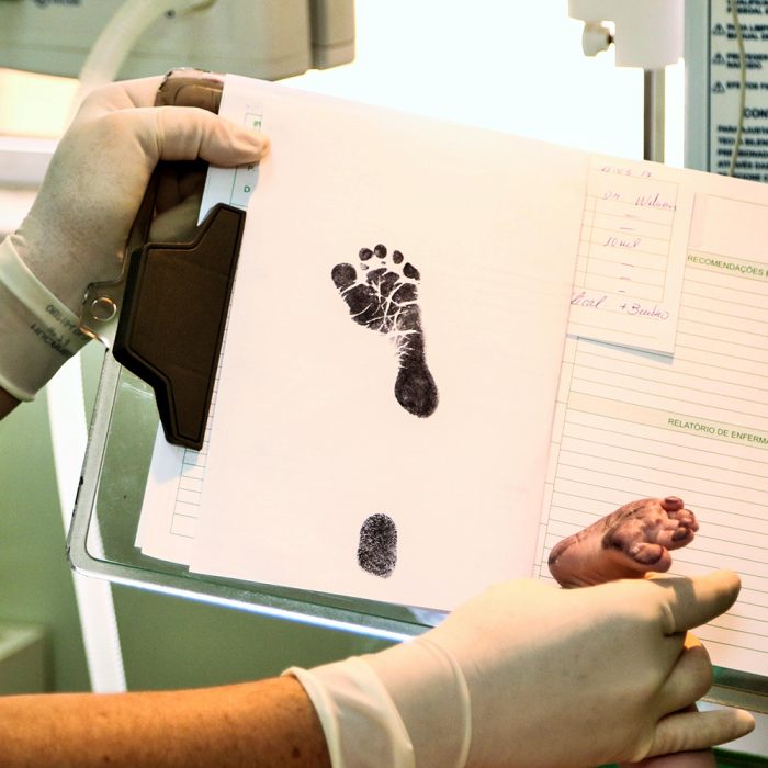 Photograph of baby's footprint on hospital chart.